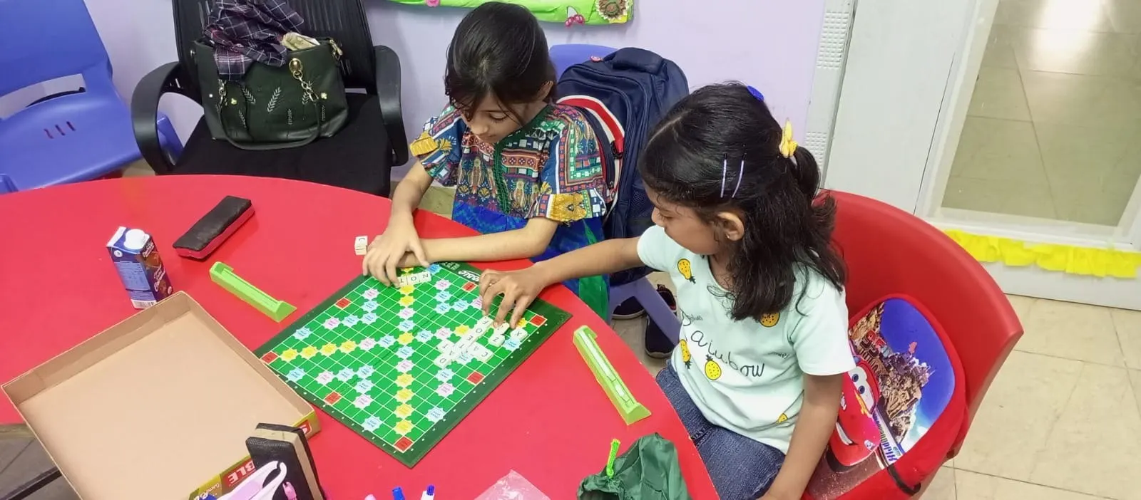 Two students concentrating on a board game in class