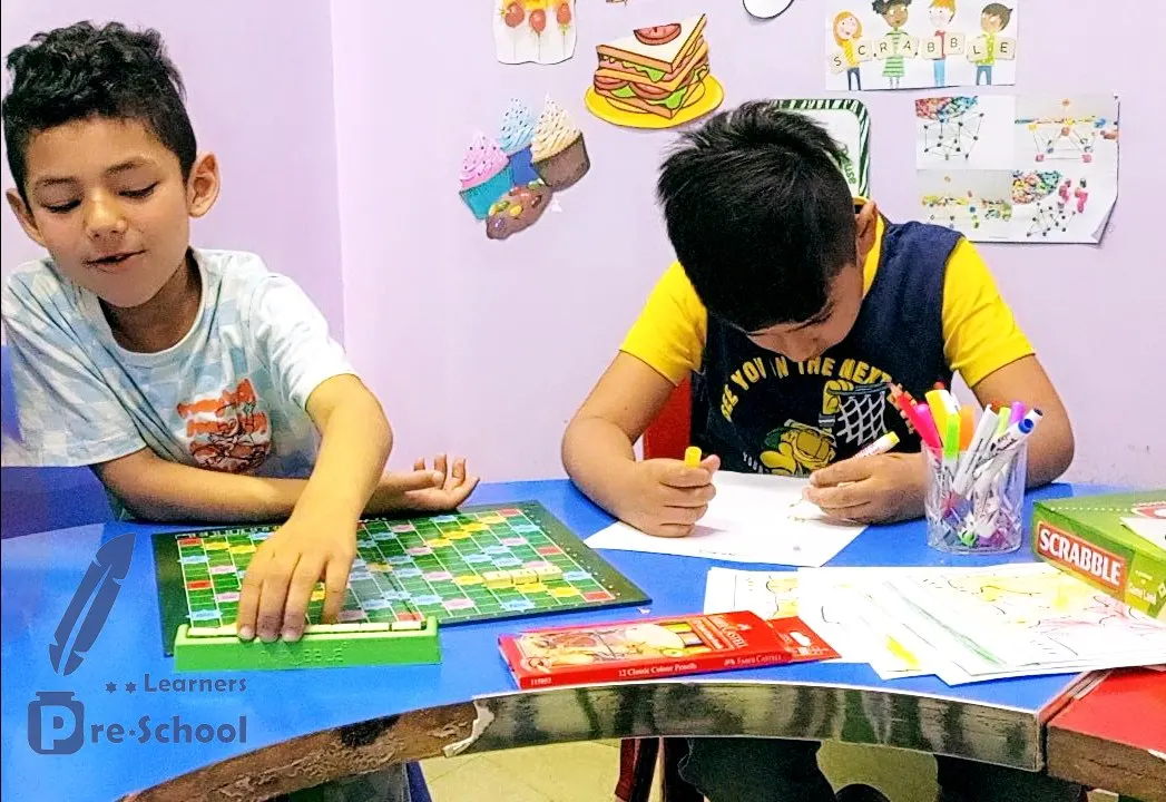 Two students playing Scrabble during a word-building class at the Junior Campus